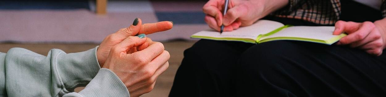 Deskundigheidsgebied Forensische psychiatrie, psychologie en orthopedagogiek (FPPO): handen van een psychiater in gesprek met een cliënt